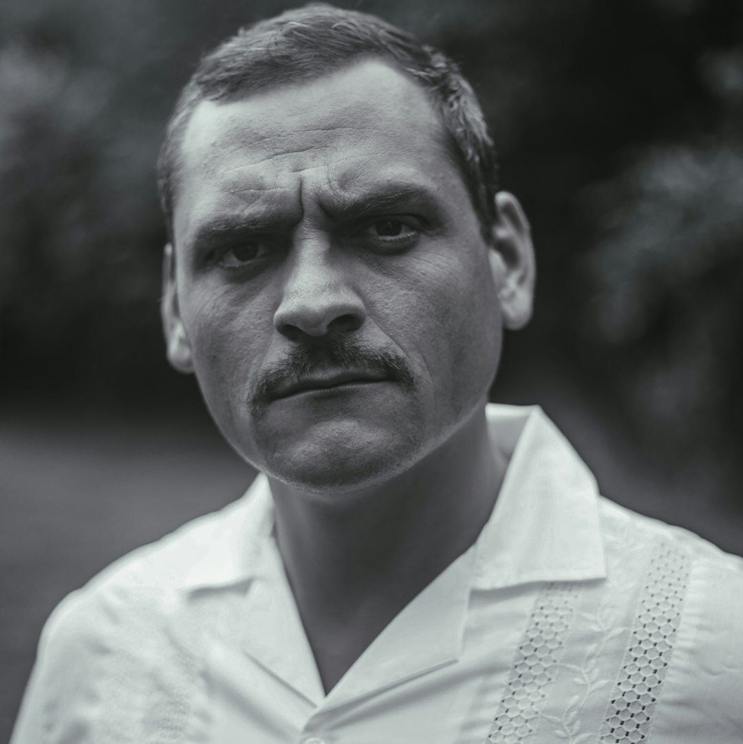 Studio portrait of a Chilean male photojournalist smiling
